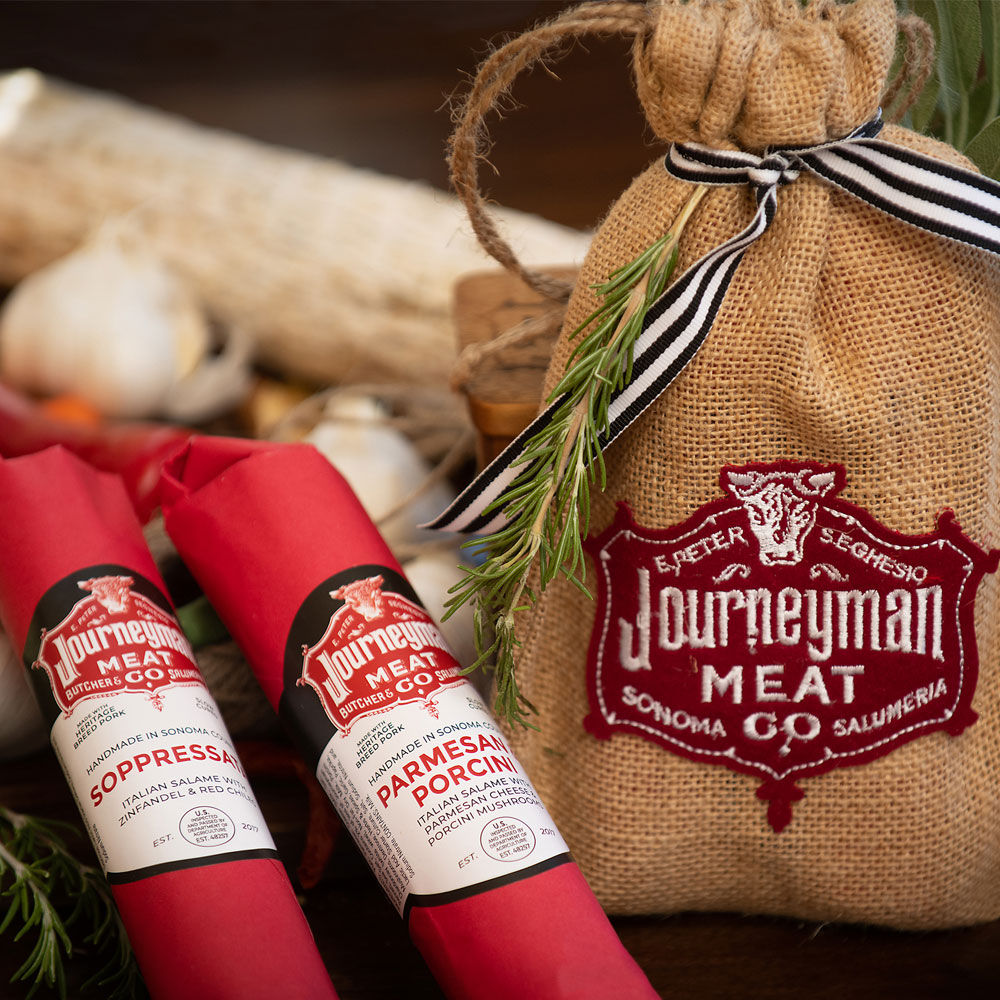 Salumi Club quarterly offering of two salumi chubs in decorative gift bag. Journeyman Meat